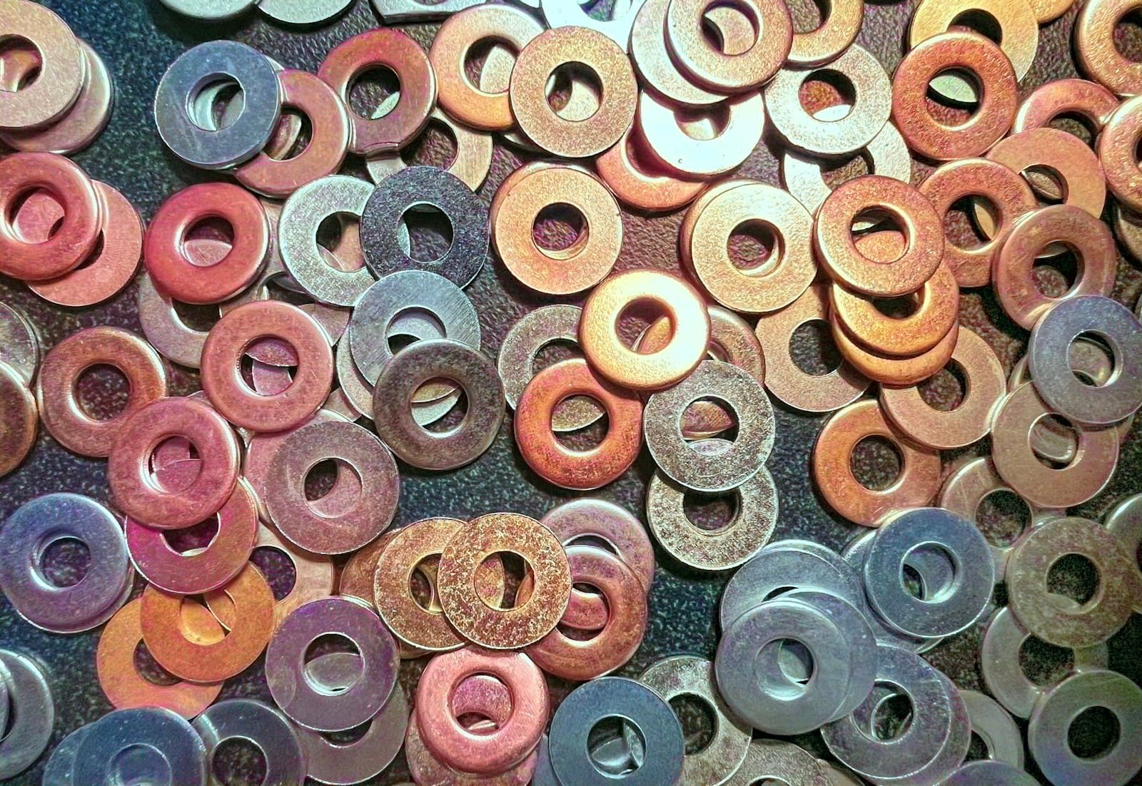 A pile of different sized metal washers
