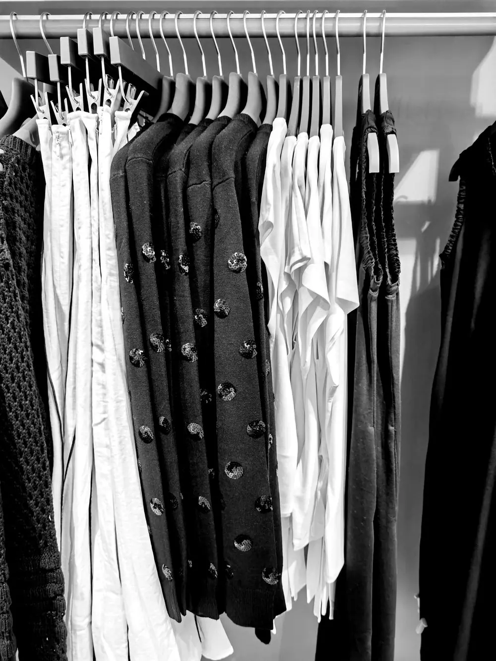 Reference photo 4: black and white clothing on hangers in a closet — abayas & kaftans we manufacture and export in bulk to Qatar