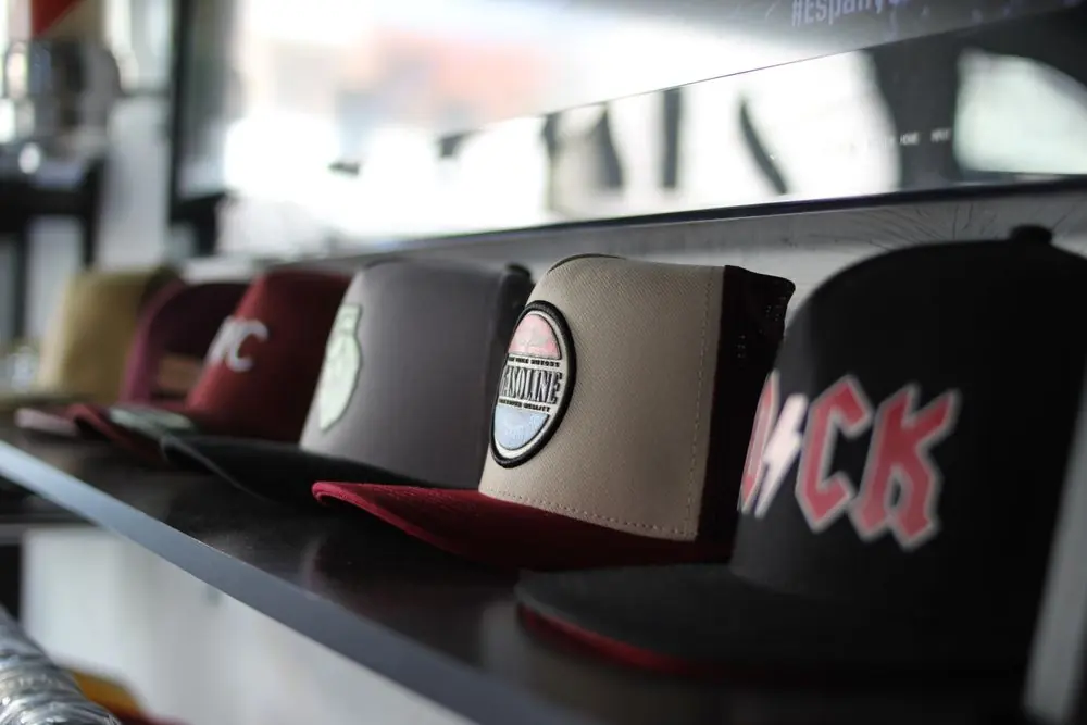Reference photo 2: baseball caps on a shop shelf — caps we manufacture and export in bulk to South Africa