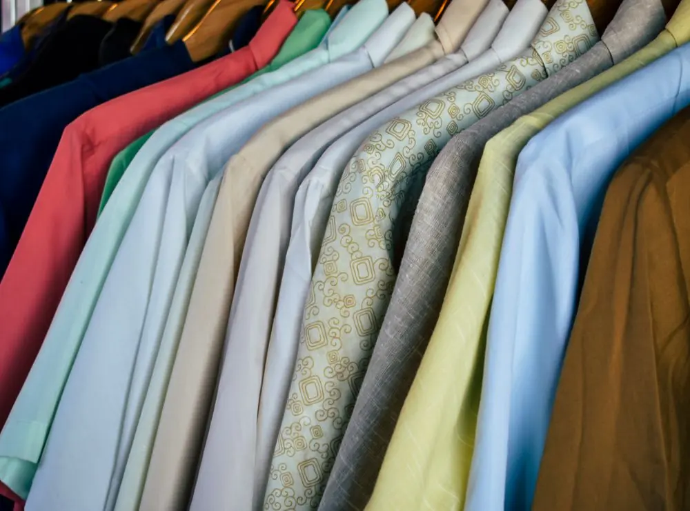 Reference photo 3: polo shirts in many colours on wooden hangers — polo t-shirts we manufacture and export in bulk to Tanzania