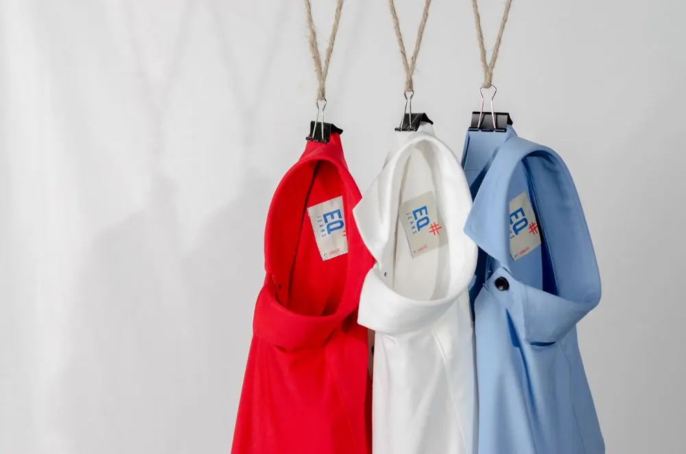 Reference photo 4: red, white and blue polo shirts on hangers — polo t-shirts we manufacture and export in bulk to Tanzania