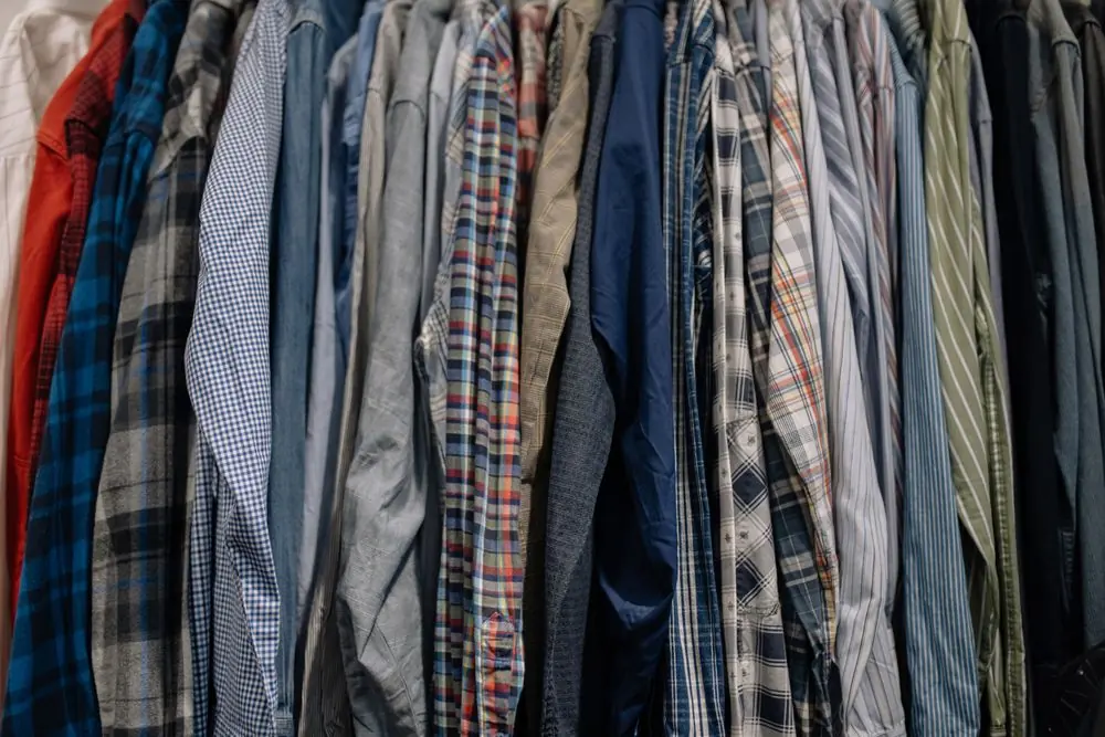 Reference photo 3: check and plaid shirts on a clothes rack — printed shirts we manufacture and export in bulk to Qatar