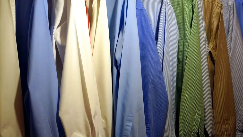 Reference photo 2: blue, cream and green uniform-style shirts in a row — school uniforms we manufacture and export in bulk to Ghana