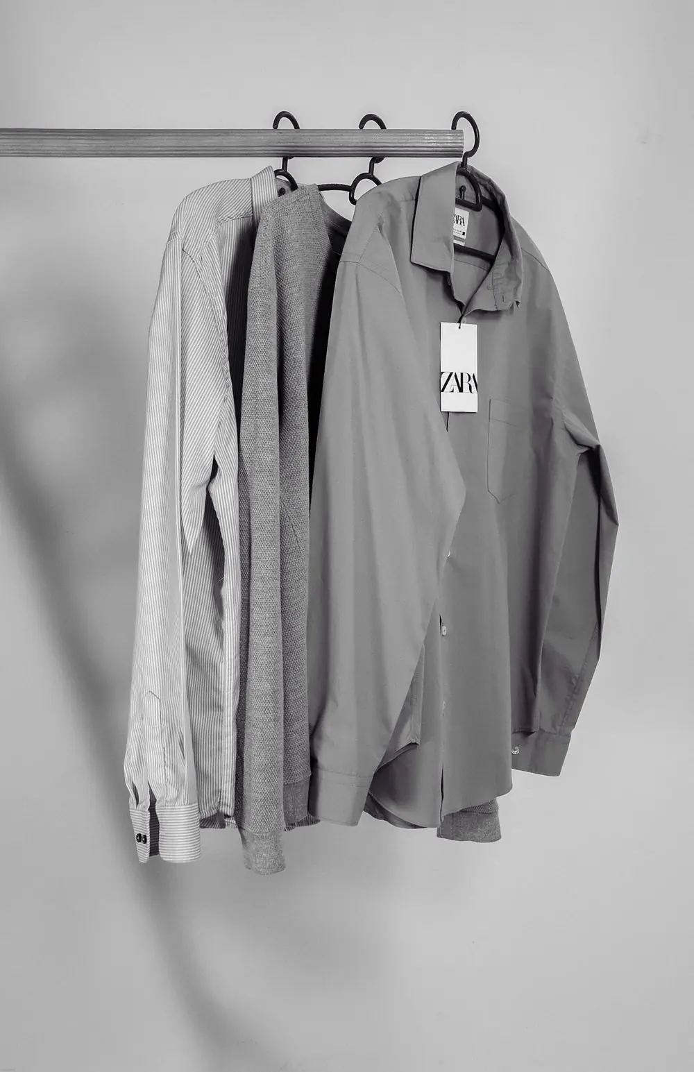 Reference photo 3: grey long-sleeve shirts on a rail — school uniforms we manufacture and export in bulk to Ghana