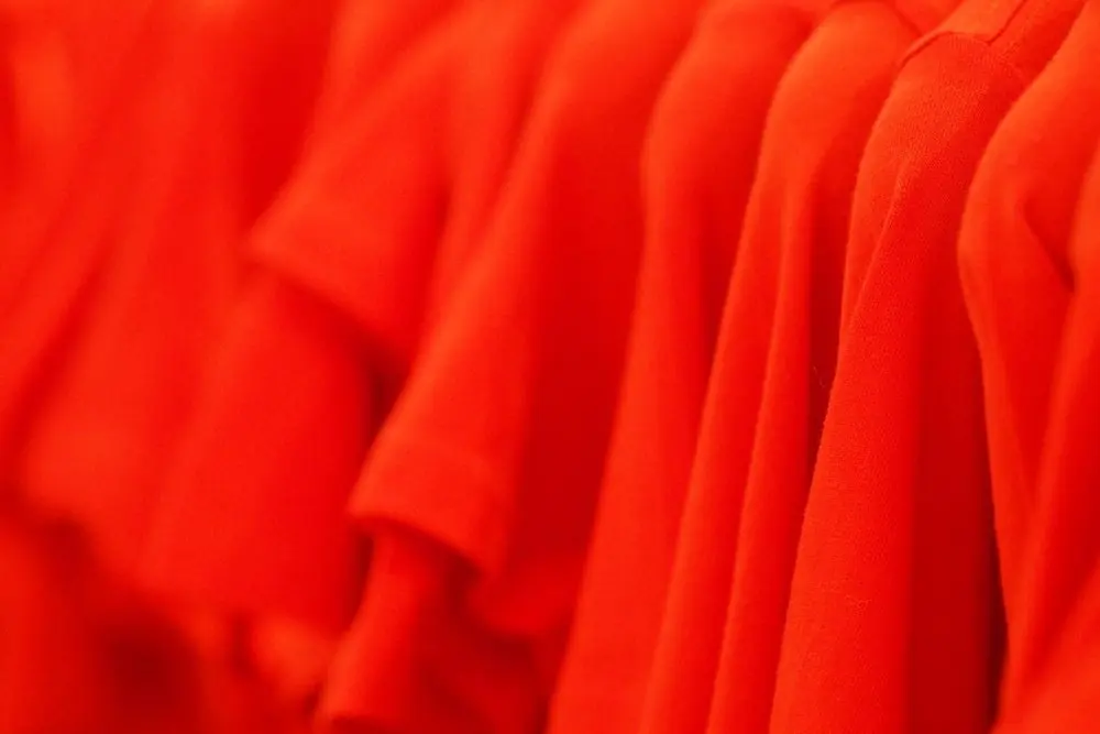 Reference photo 3: red T-shirts in a row on a rail — sportswear & jerseys we manufacture and export in bulk to South Africa