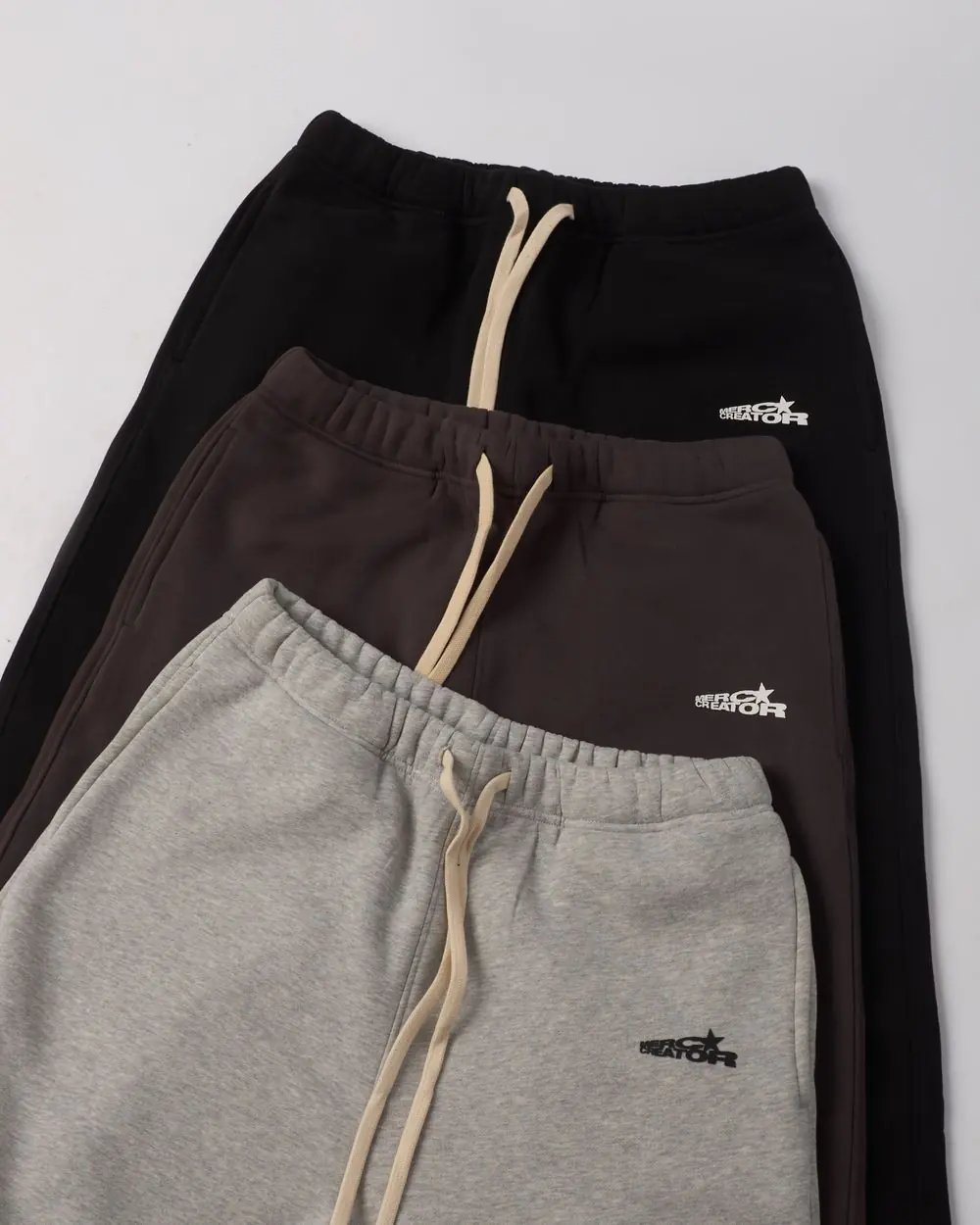 Reference photo 2: stacked drawstring sweatpants — track pants & shorts we manufacture and export in bulk to Nigeria