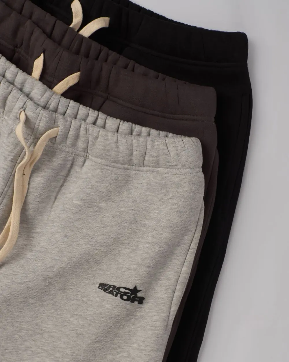 Reference photo 3: folded sweatpants laid flat — track pants & shorts we manufacture and export in bulk to Nigeria