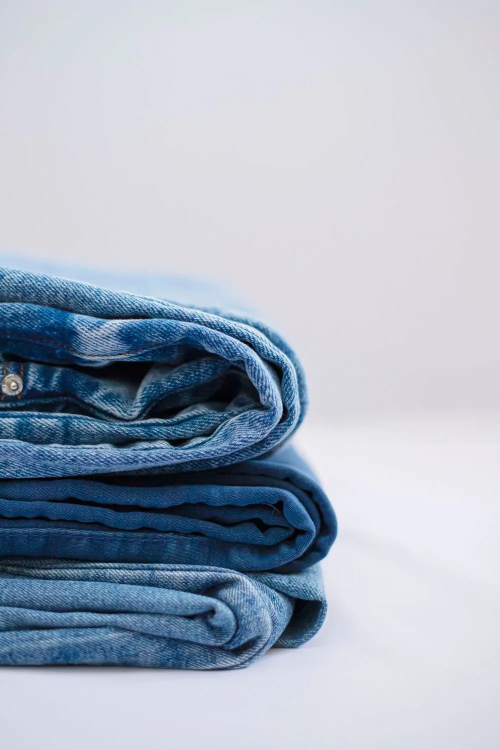 Reference photo 4: folded denim trousers in a stack — trousers & cargo pants we manufacture and export in bulk to United States